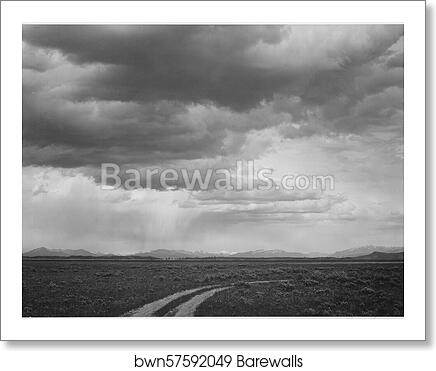 Roadway, low horizon, mountains, clouded sky, "Near (Grand) Teton National Park,".  Photographs of National Parks and Monuments, compiled 1941 - 1942, documenting the period ca. 1933 - 1942 by Ansel Adams (1902-1984), Art Print