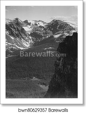 View of snow-capped mountain timbered area below, "In Rocky Mountain National Park," Colorado. (Vertical Orientation).  Photographs of National Parks and Monuments, compiled 1941 - 1942, documenting the period ca. 1933 - 1942 by Ansel Adams (1902-1984), Art Print