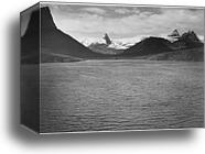 Looking across toward snow-capped mountains, lake in foreground, "St. Mary's Lake, Glacier National Park," Montana.  Photographs of National Parks and Monuments, compiled 1941 - 1942, documenting the period ca. 1933 - 1942 by Ansel Adams (1902-1984), Canvas Print