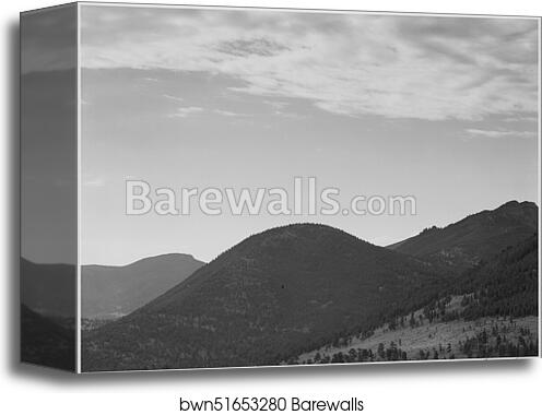 View of hill with trees, clouded sky, "In Rocky Mountain National Park," Colorado.  Photographs of National Parks and Monuments, compiled 1941 - 1942, documenting the period ca. 1933 - 1942 by Ansel Adams (1902-1984), Canvas Print