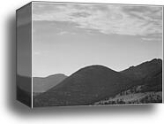 View of hill with trees, clouded sky, "In Rocky Mountain National Park," Colorado.  Photographs of National Parks and Monuments, compiled 1941 - 1942, documenting the period ca. 1933 - 1942 by Ansel Adams (1902-1984), Canvas Print