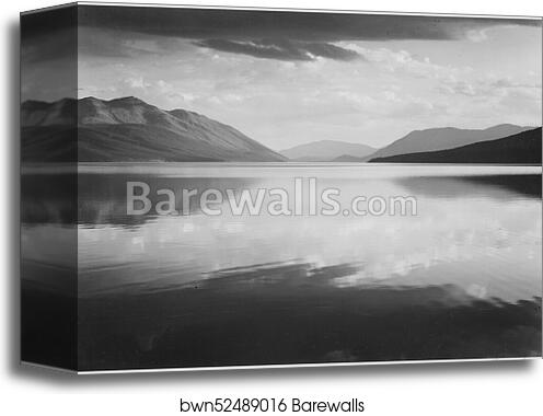 Looking across lake toward mountains, "Evening, McDonald Lake, Glacier National Park," Montana.  Photographs of National Parks and Monuments, compiled 1941 - 1942, documenting the period ca. 1933 - 1942 by Ansel Adams (1902-1984), Canvas Print