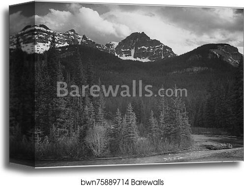 Stream in foreground, with view of trees and snow on mountains. "Mountains - Northeast Portion, Yellowstone National Park," Wyoming.  Photographs of National Parks and Monuments, compiled 1941 - 1942, documenting the period ca. 1933 - 1942 by Ansel Adams (1902-1984), Canvas Print