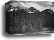 Stream in foreground, with view of trees and snow on mountains. "Mountains - Northeast Portion, Yellowstone National Park," Wyoming.  Photographs of National Parks and Monuments, compiled 1941 - 1942, documenting the period ca. 1933 - 1942 by Ansel Adams (1902-1984), Canvas Print