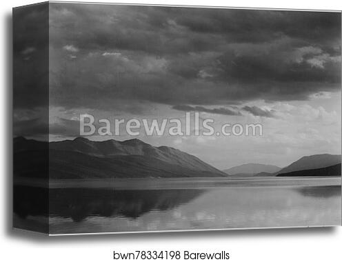 Looking across lake to mountains and clouds, "Evening, McDonald Lake, Glacier National Park," Montana.  Photographs of National Parks and Monuments, compiled 1941 - 1942, documenting the period ca. 1933 - 1942 by Ansel Adams (1902-1984), Canvas Print