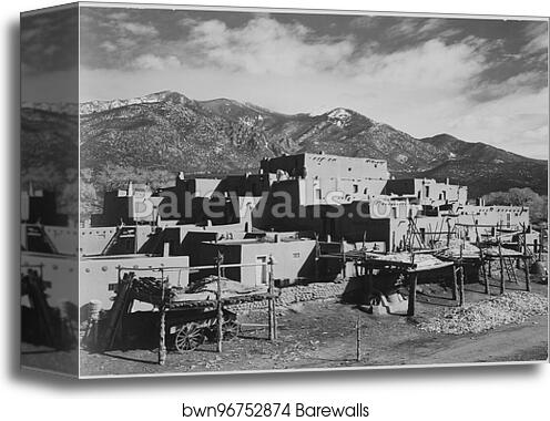 Full view of city, mountains in background, "Taos Pueblo National Historic Landmark, New Mexico, 1941.".  Photographs of National Parks and Monuments, compiled 1941 - 1942, documenting the period ca. 1933 - 1942 by Ansel Adams (1902-1984), Canvas Print